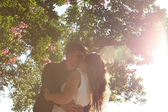 Couple hug and kiss in sun